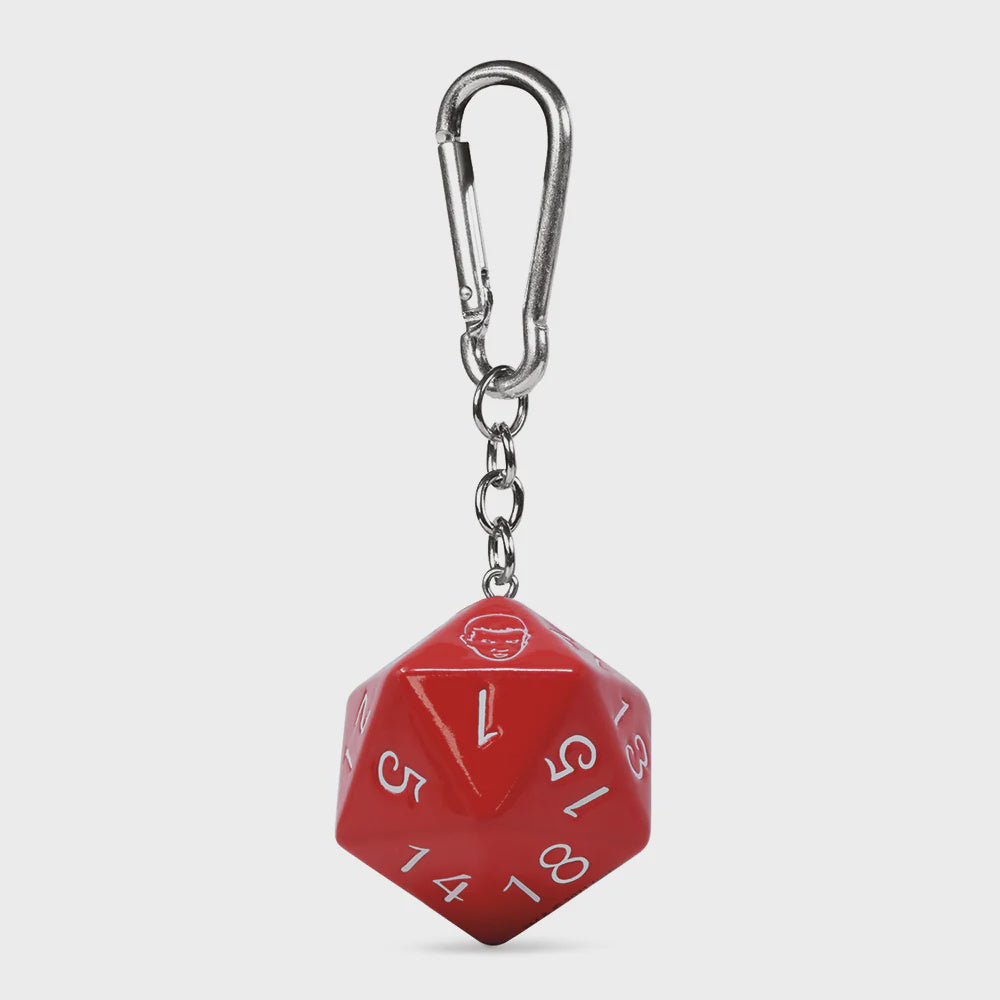 Red polyhedral die keychain with a carabiner on a light gray background
