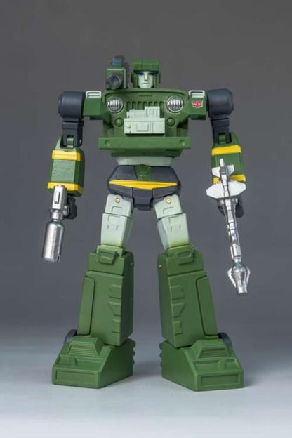 Green robot toy figure on a gray background