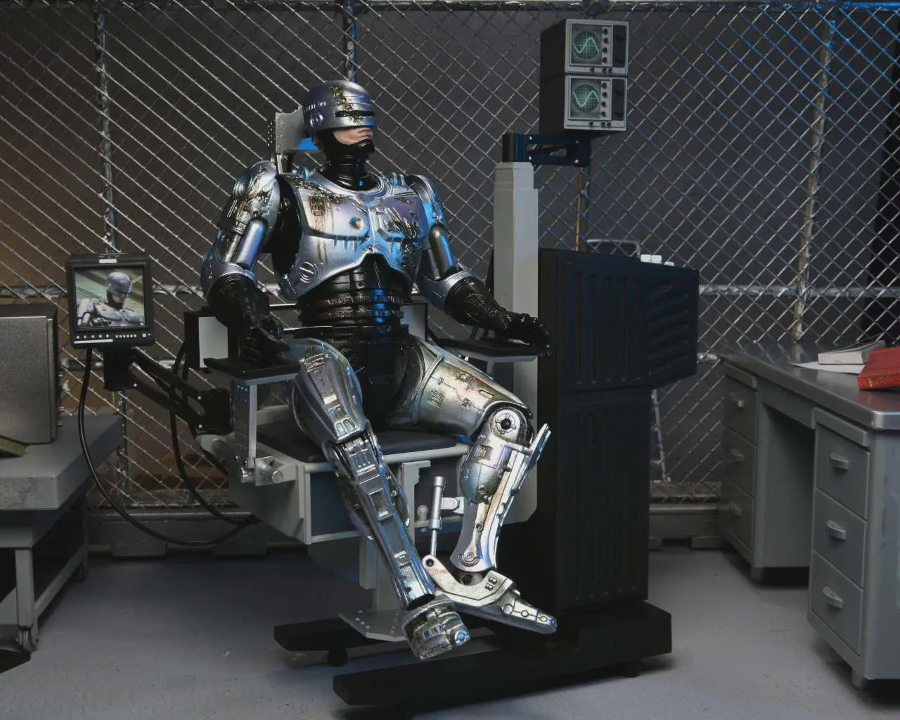 Robotic suit in a laboratory setting with cables and equipment.