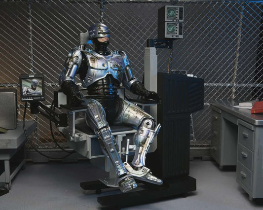 Robotic suit in a laboratory setting with cables and equipment.