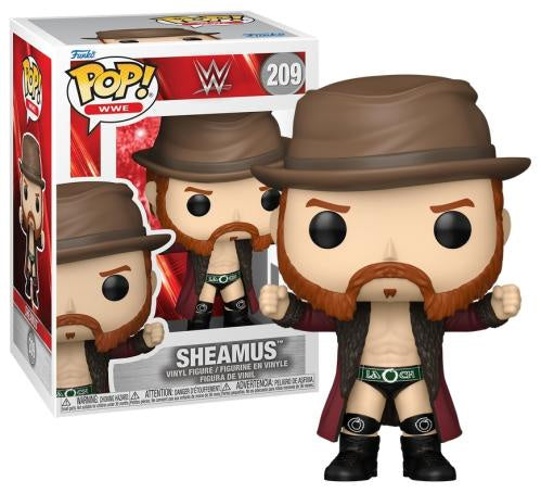 Funko Pop! WWE Sheamus vinyl figure shown next to its retail box. The figure wears a brown fedora, brown jacket, green and black wrestling trunks, and black boots, with a red beard.
