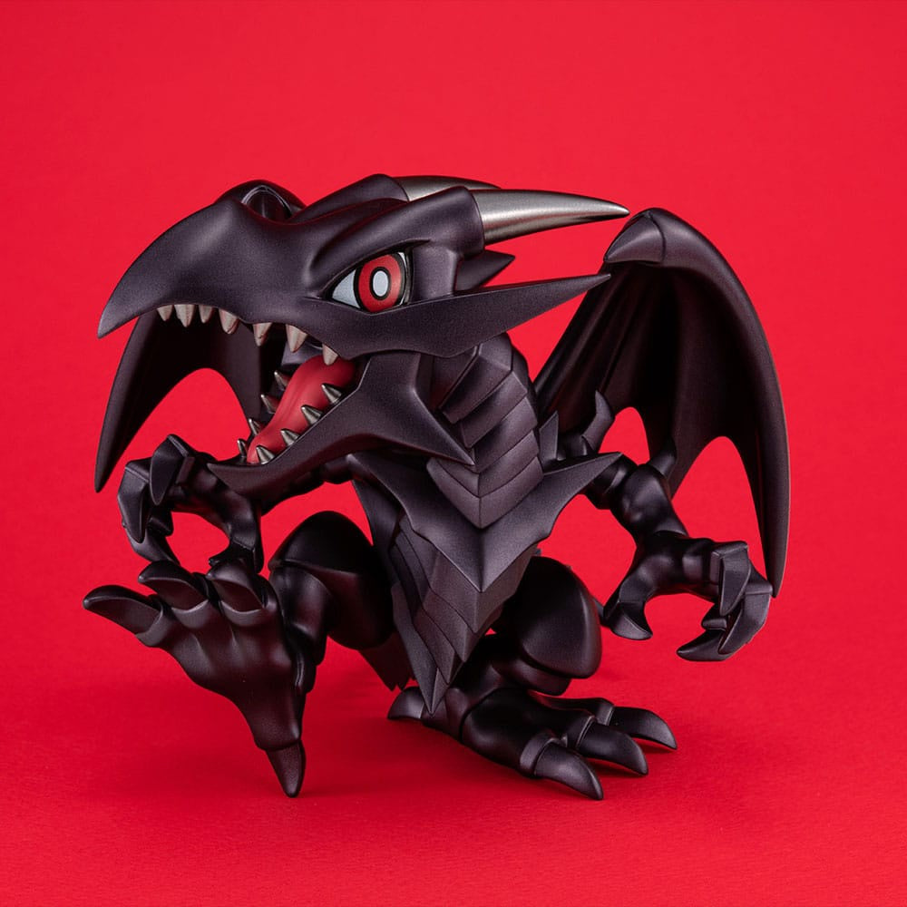 Black dragon-like creature toy on a red background