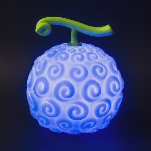 Decorative lamp designed to look like a fruit with blue light, featuring a rounded body with indentations and a green stem-like protrusion on top.